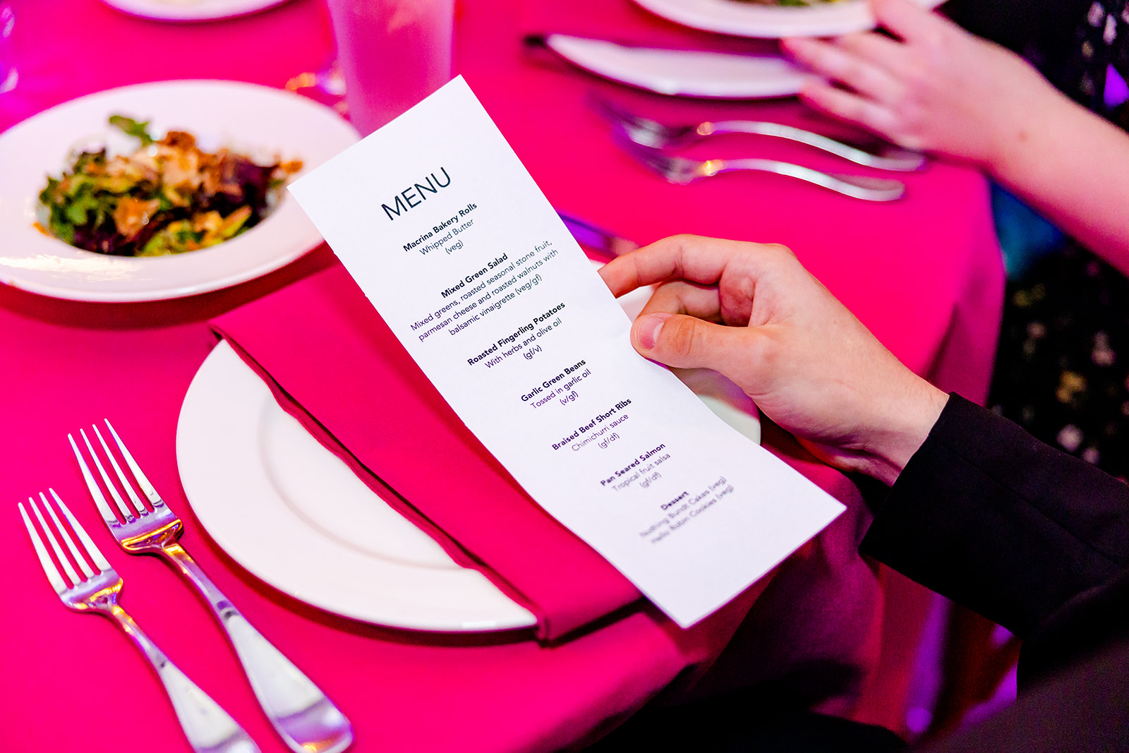 Details of a menu for a Mitzvah with pink tables being held