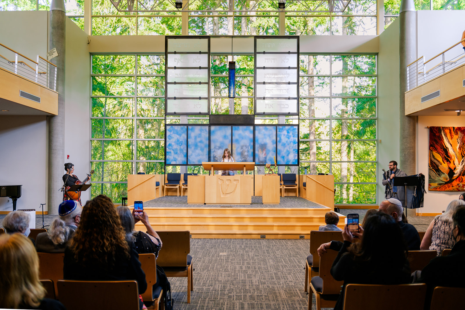 A girl stands alone at the altar while reading from the Torah