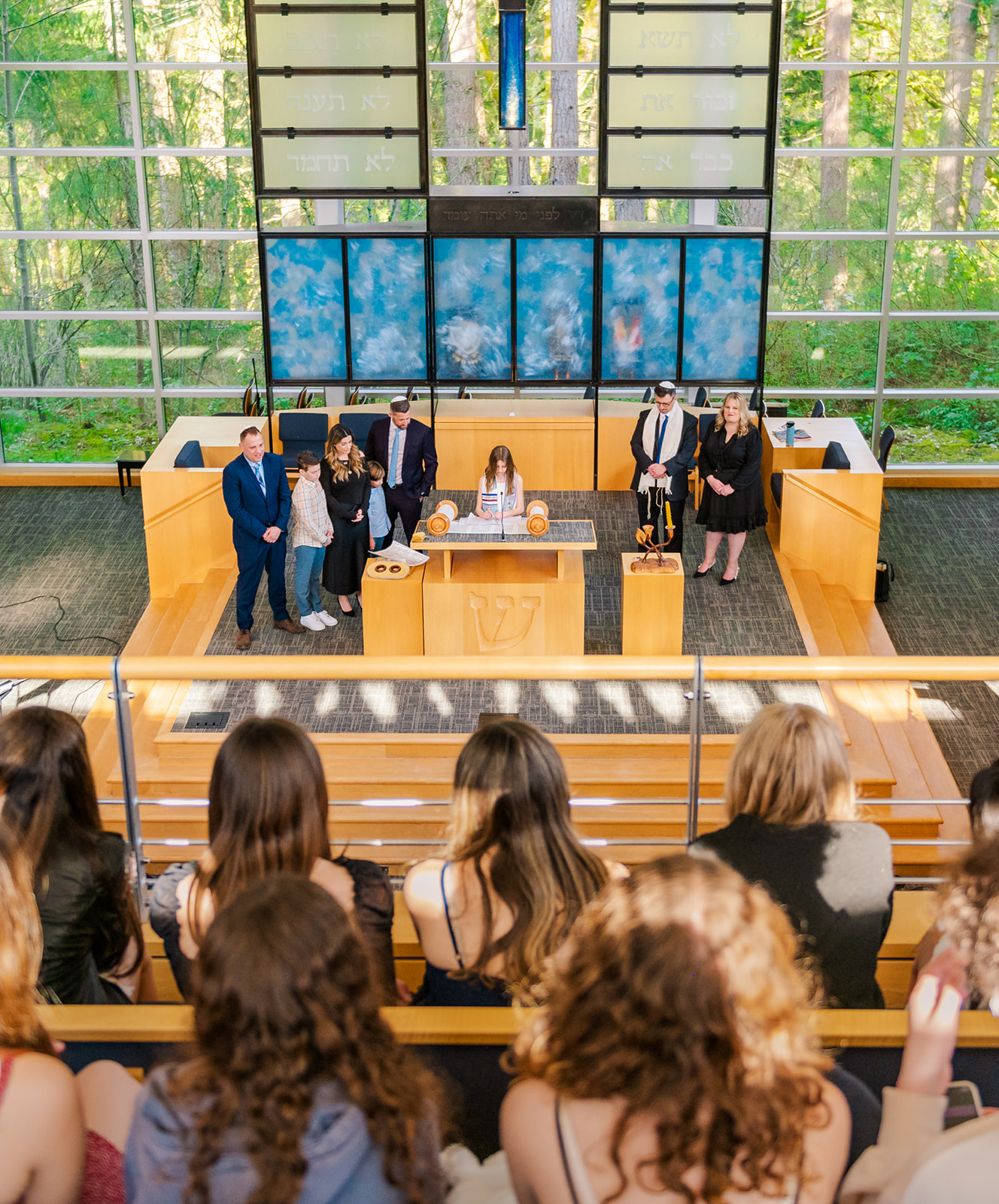 A teen girl stands at the altar reading from the Torah after attending Seattle Hebrew Academy