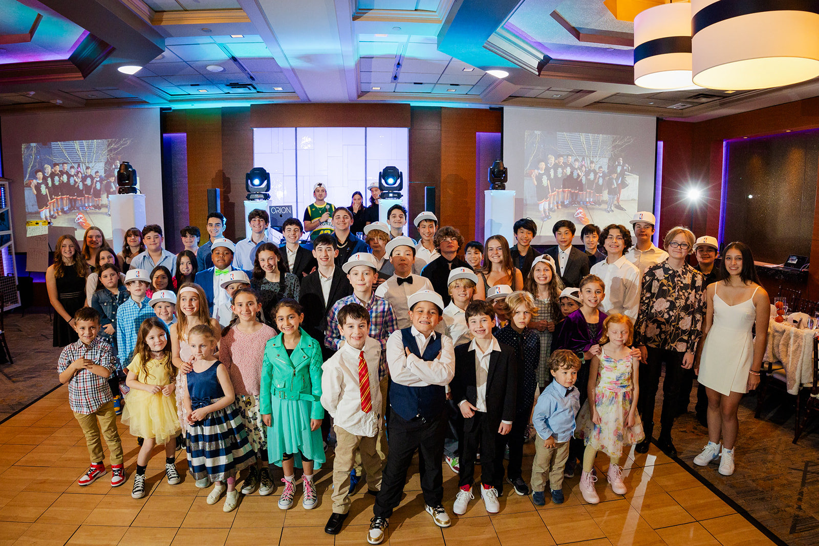 A happy bunch of young people stand on the dance floor together thanks to Kosher Catering Seattle