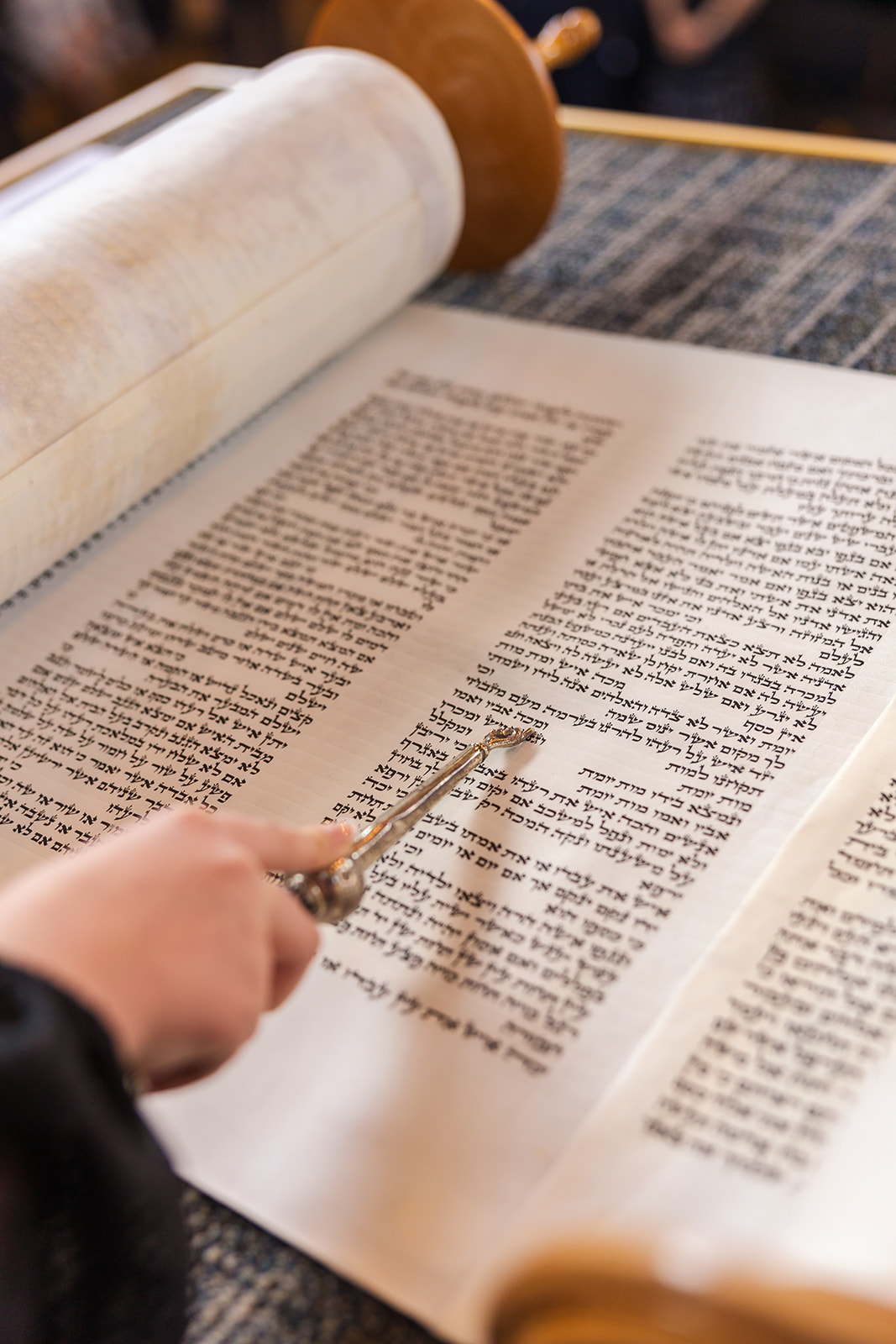 Details of a girl reading from the Torah with the pointer at one of the great Bellevue Synagogues