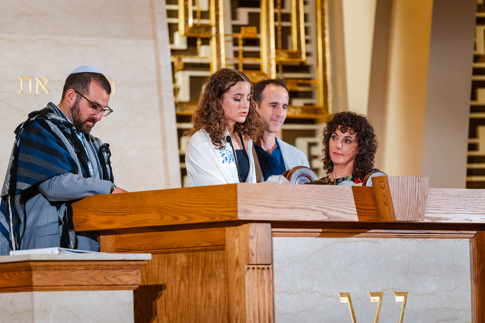 A young woman stands and reads from the torah during her Mitzvah at Chabad of Central Cascades