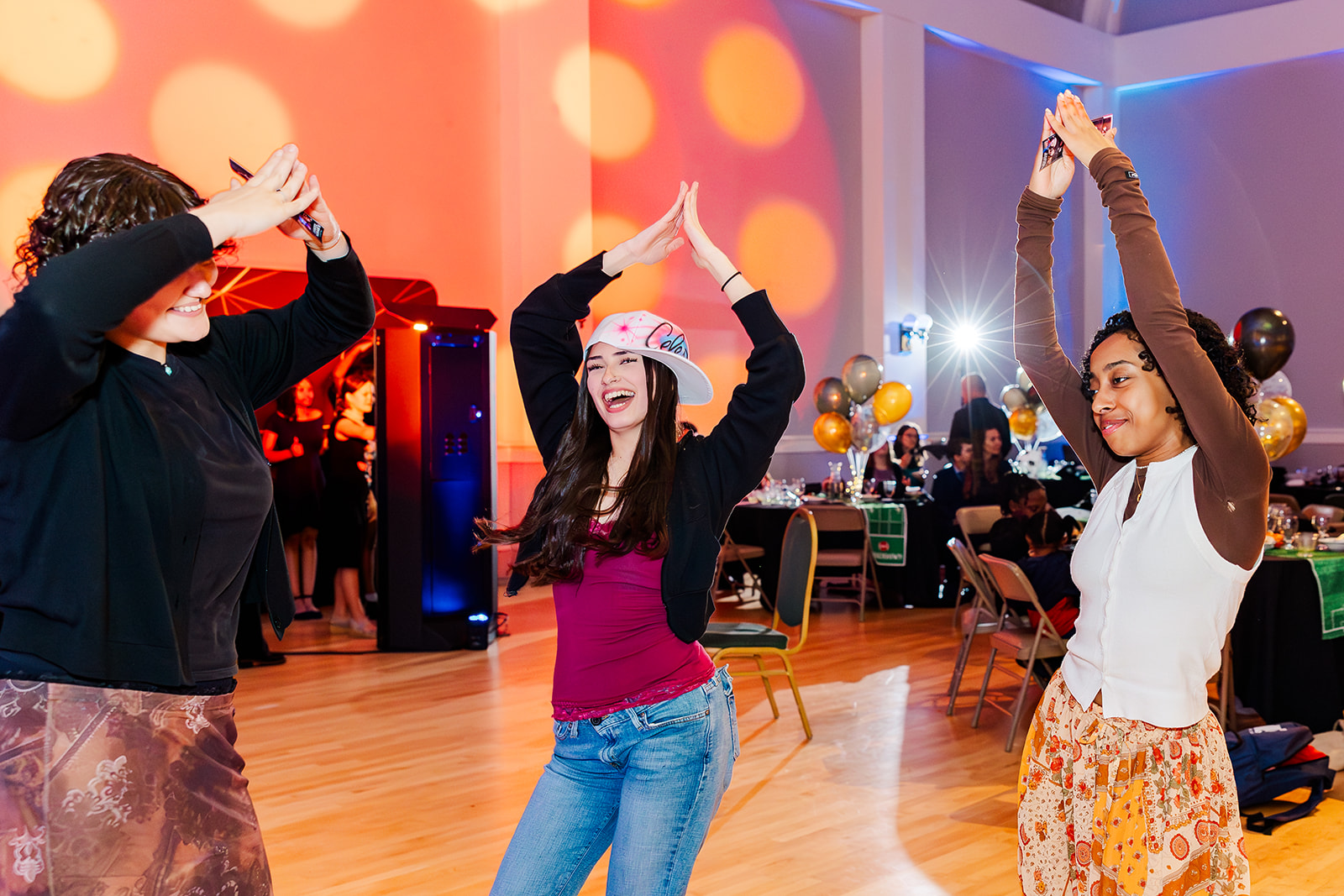 teenagers dance on a dance floor during a Mitzvah planned by Pink Blossom Events