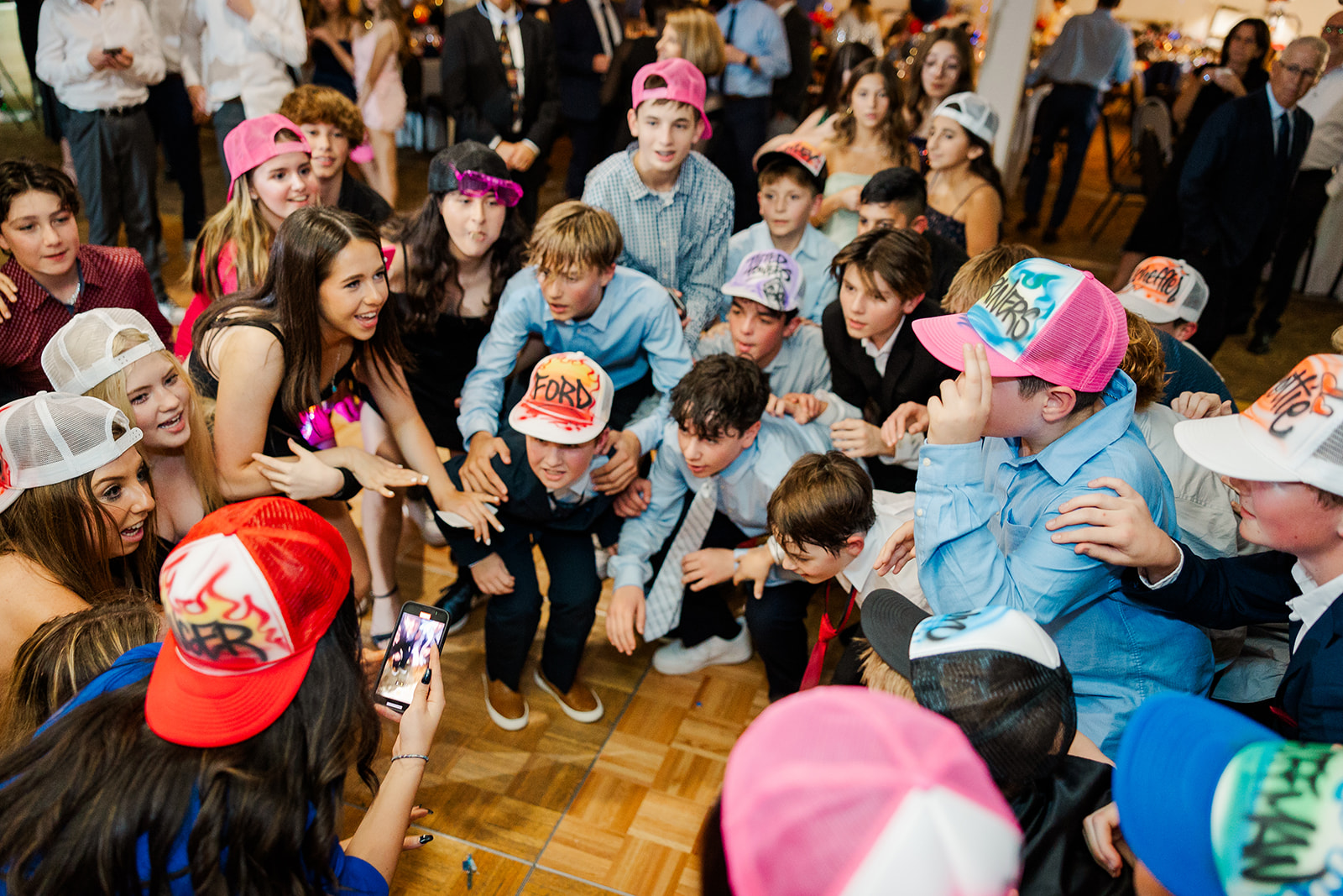 A group of boys in custom graffiti hats get low on the dance floor thanks to a DJ in Kirkland, WA
