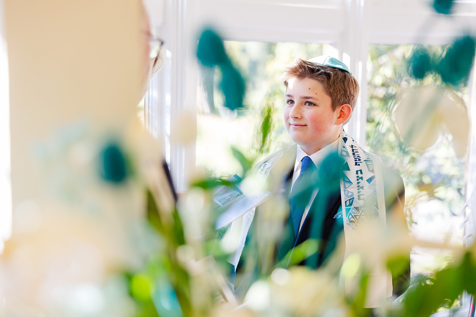 A teen boy smiles in his Bar Mitzvah attire after finding perfect Issaquah event space