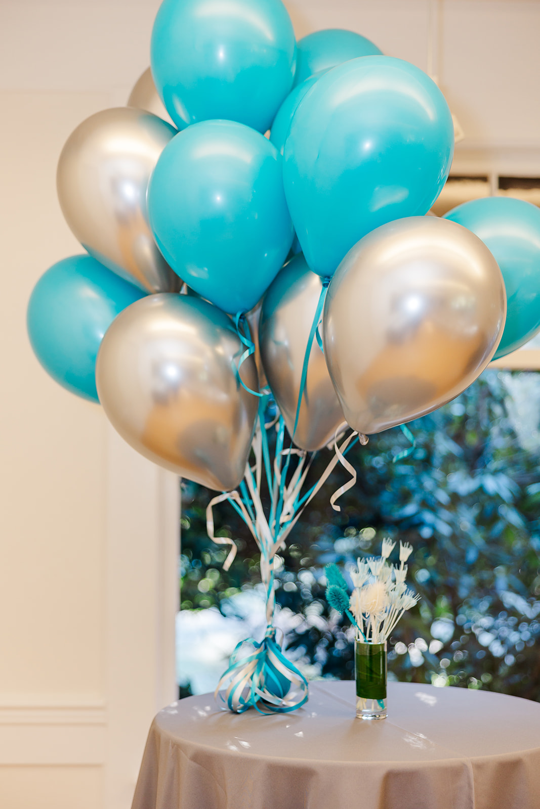 Details of blue and silver balloons tied together on a table