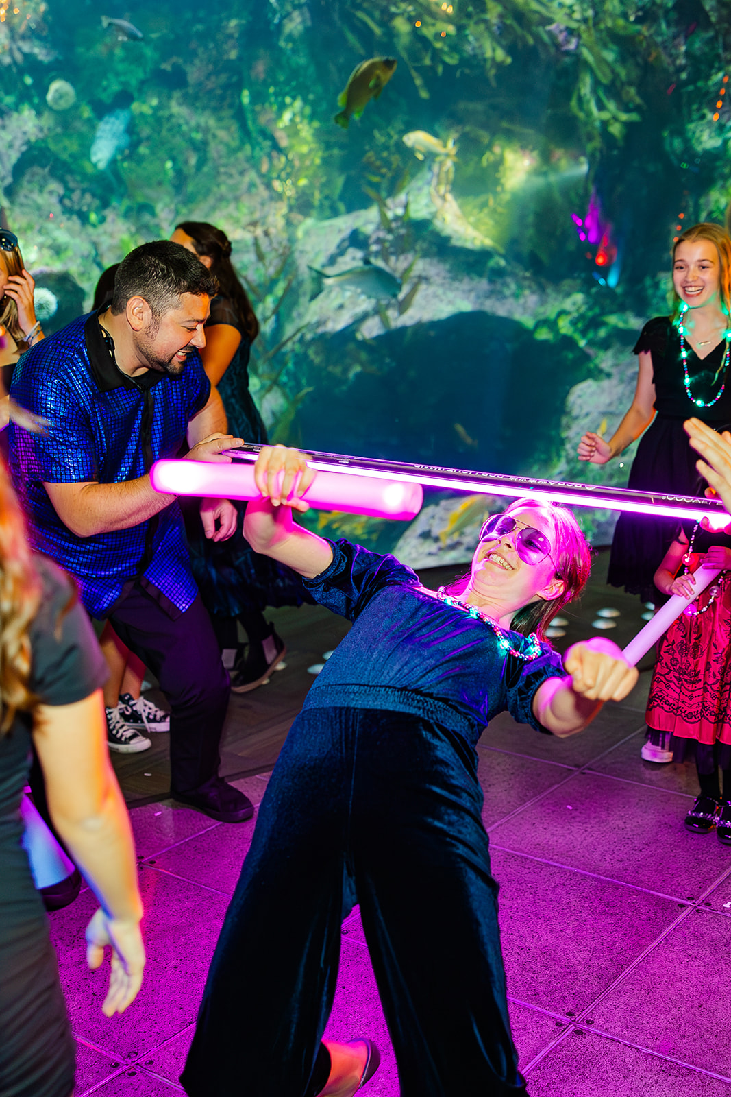 A teen does a limbo in a blue romper at the Seattle Aquarium after enjoying a bakery on Mercer Island