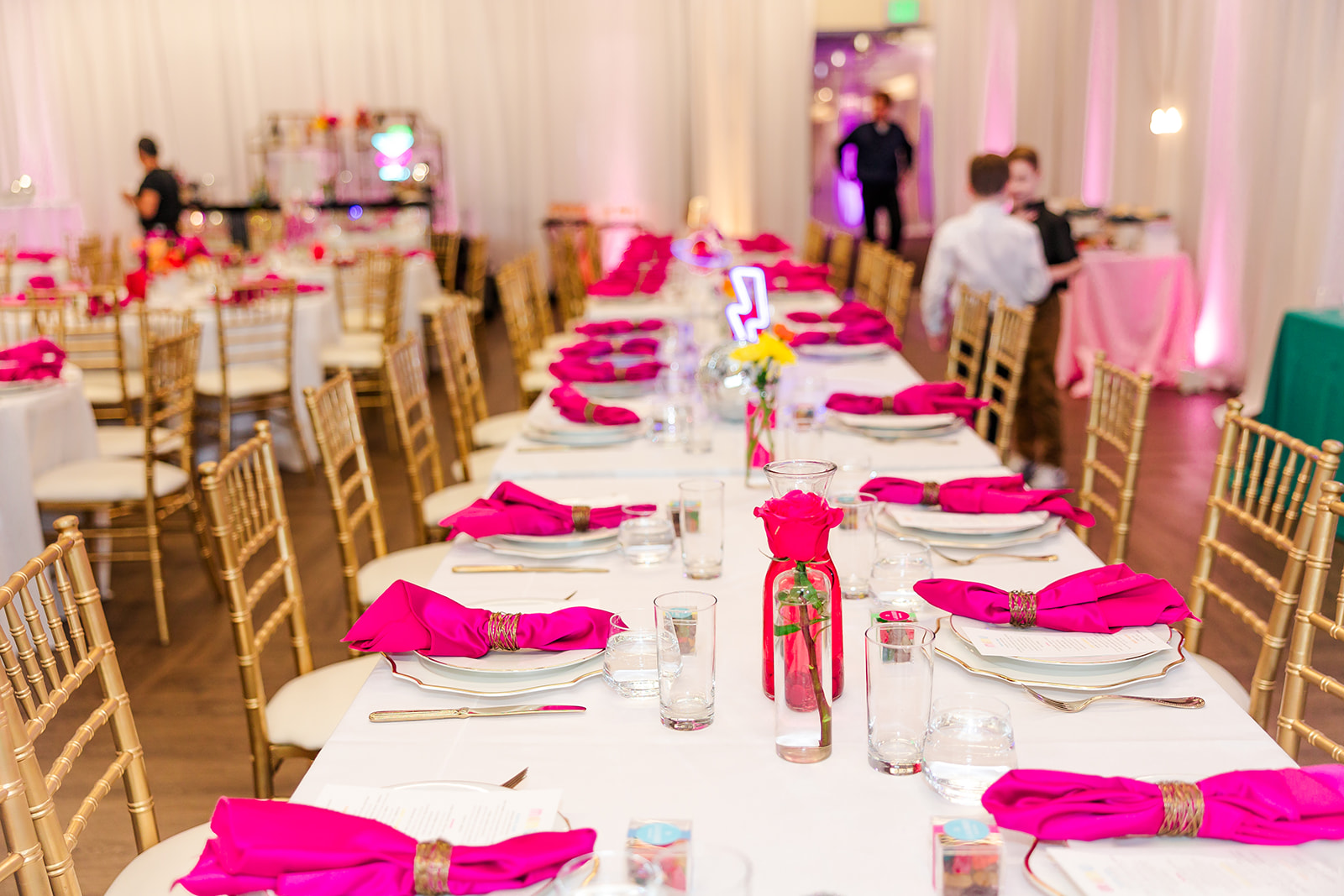 Details of a reception table setting with pink napkins and roses done by event decorators in Seattle