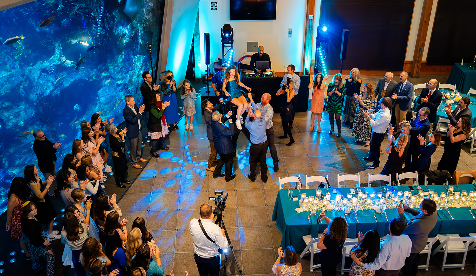 A look down at a reception and dance happening during a bat mitzvah with event lighting in Seattle