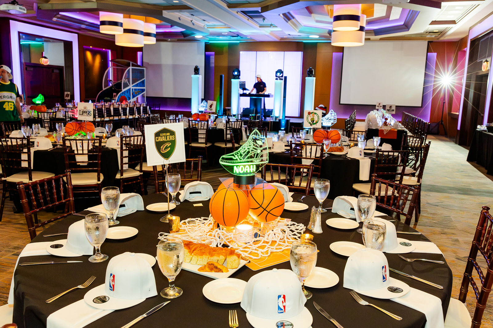 NBA hats sit at place settings for a reception after finding perfect party favors in Seattle