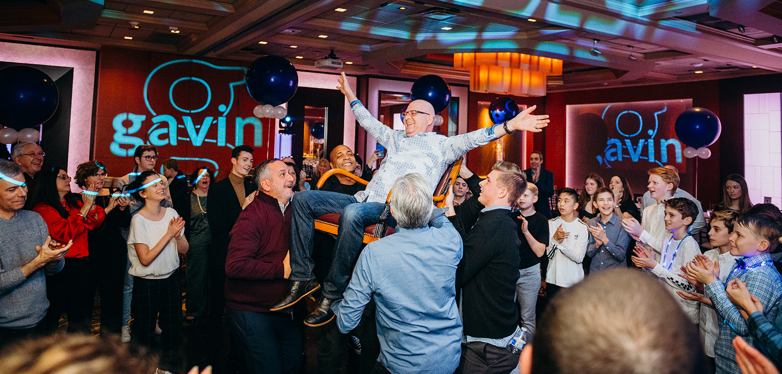 A man is lifted on the dance floor during a bar mitzvah dance